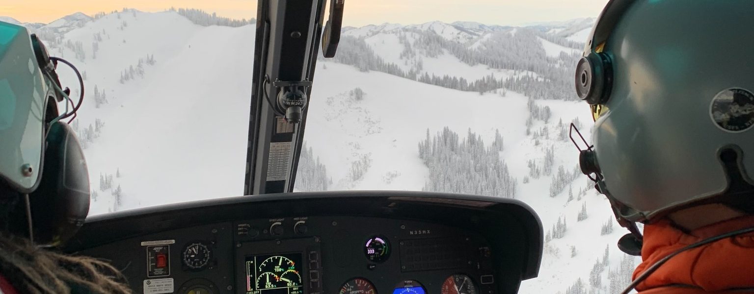 View of pilot and co-pilot in the Teton County Search & Rescue helicopter in winter