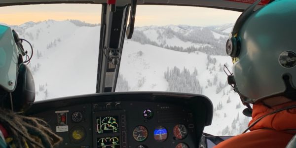 View of pilot and co-pilot in the Teton County Search & Rescue helicopter in winter