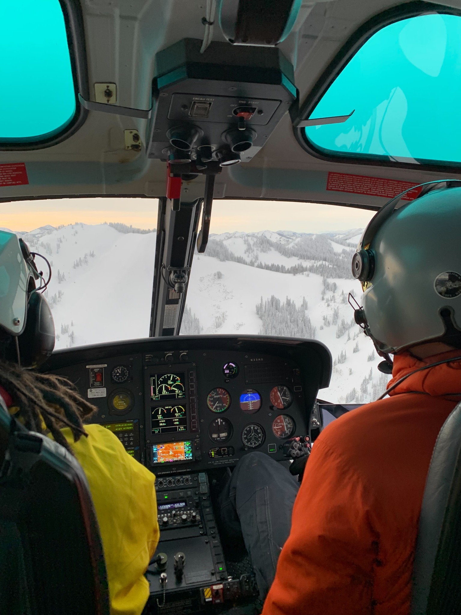 View of pilot and co-pilot in the Teton County Search & Rescue helicopter in winter