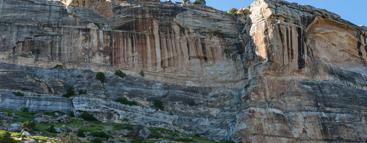 A large canyon in Sinks Canyon State Park near Lander, Wyoming, has lush vegetation and intricate rocky details.