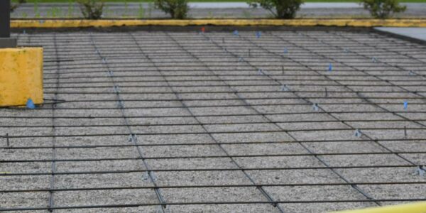 A parking lot area with wire formwork set up, ready to have concrete poured and cured in place.